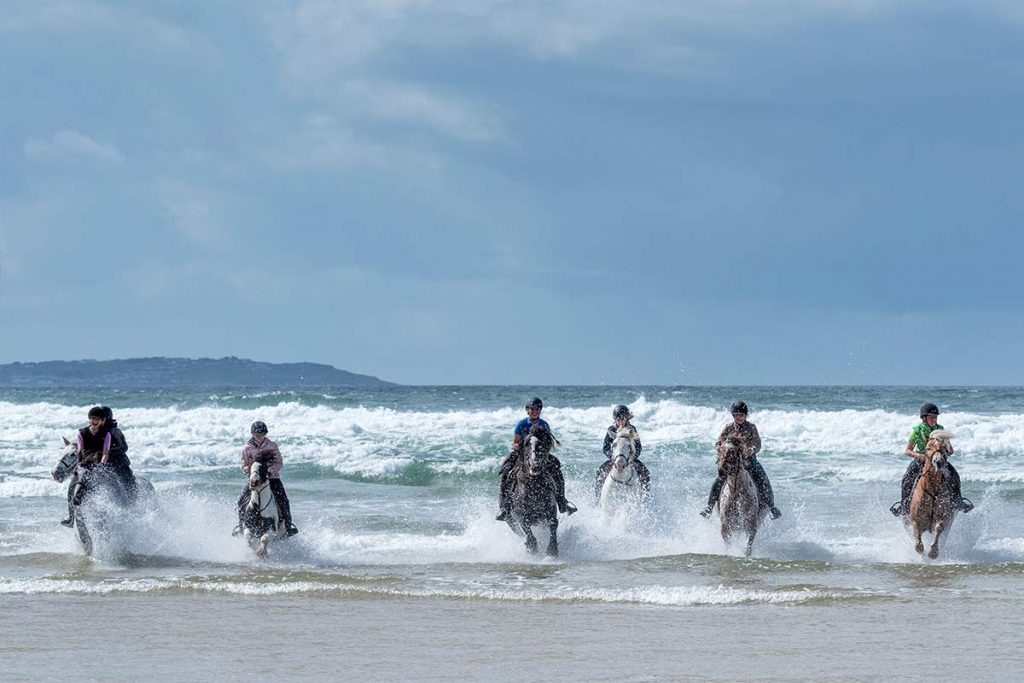 horse riders at the beach in Teenage Equestrian Camps in Ireland