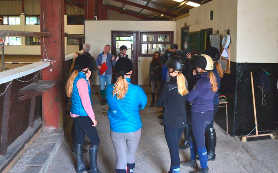 students in equestrian lesson