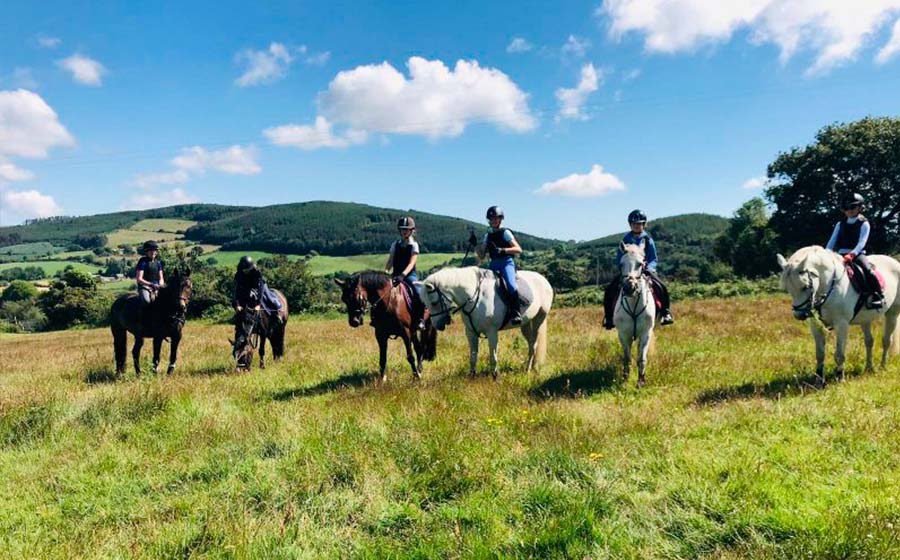 Horse riders enjoying a peaceful hack in countryside